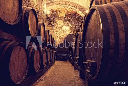 Picture of Wooden barrels with wine in a wine vault Italy
